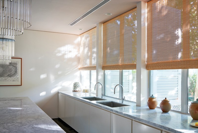 Sunlit kitchen with woven shades