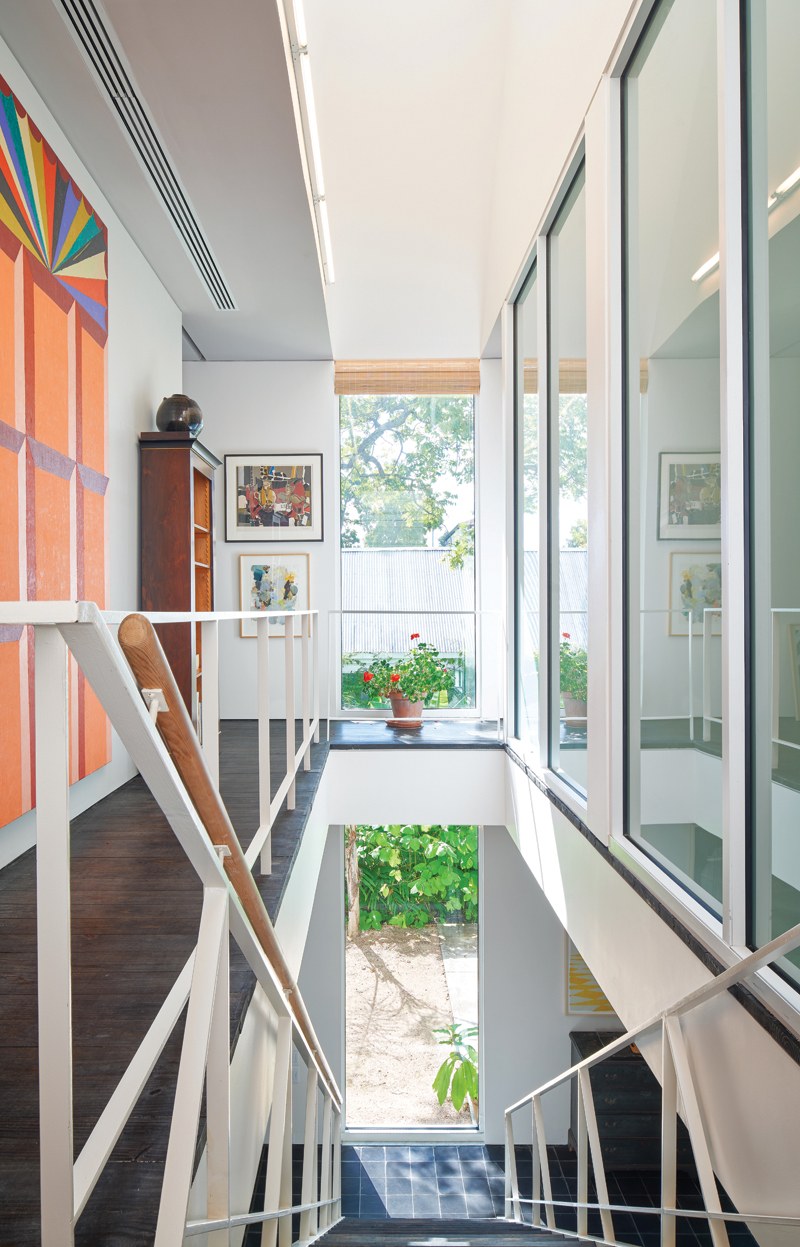 Tall stair hall with colorful artwork