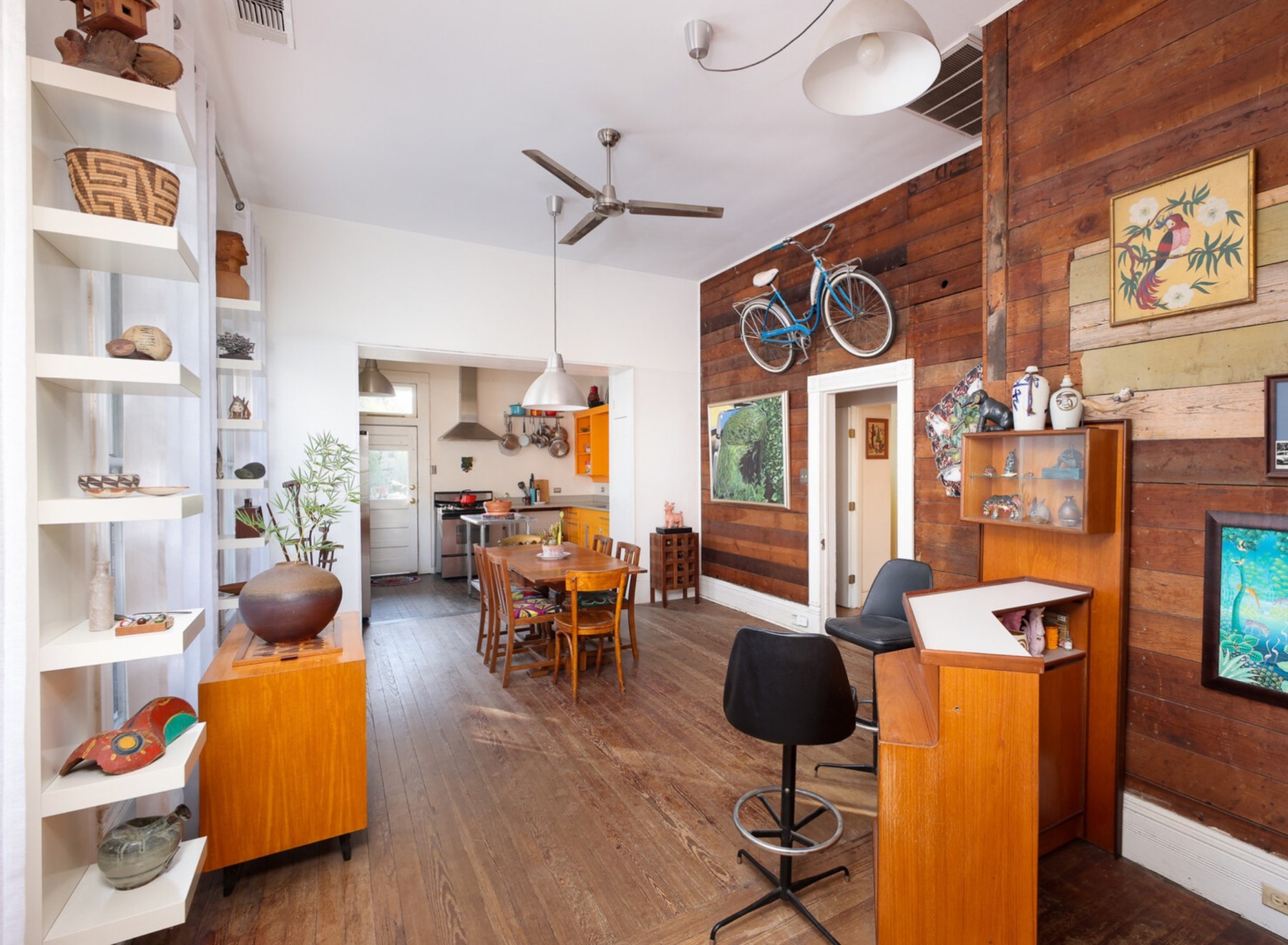 Eclectic interior with wood wall and art